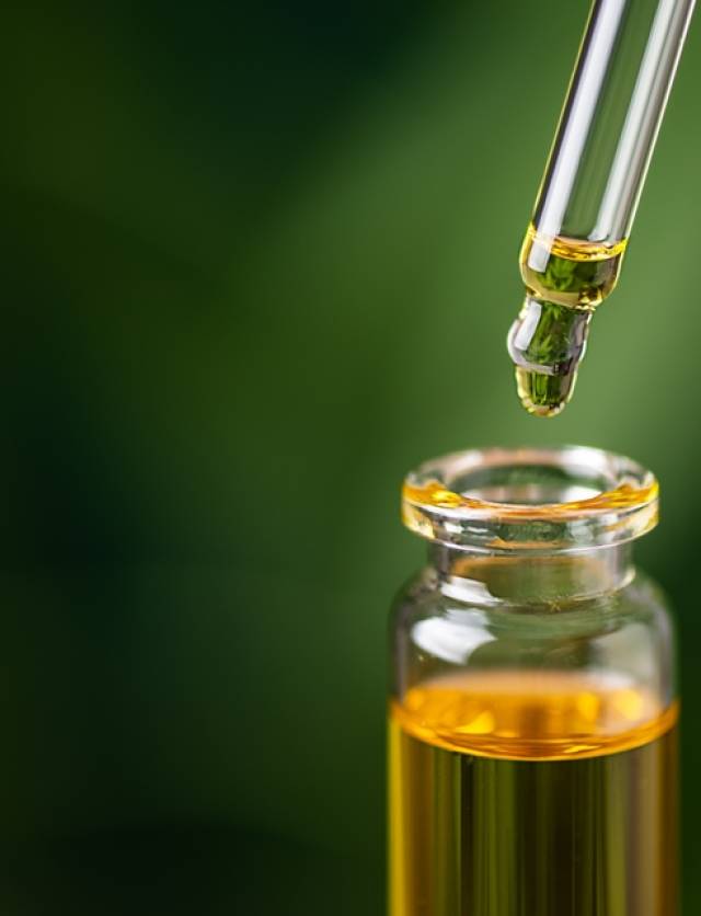 Cbd,Hemp,Oil,On,Cannabis,Leaf,Background.,Cbd,Oil,Extract.
