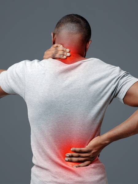 African,Man,With,Neck,And,Back,Pain,,Rubbing,His,Painful